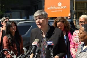 CEO Liz Roberts speaks at podium