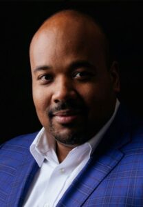 Man wearing a blue suit jacket and a white shirt.